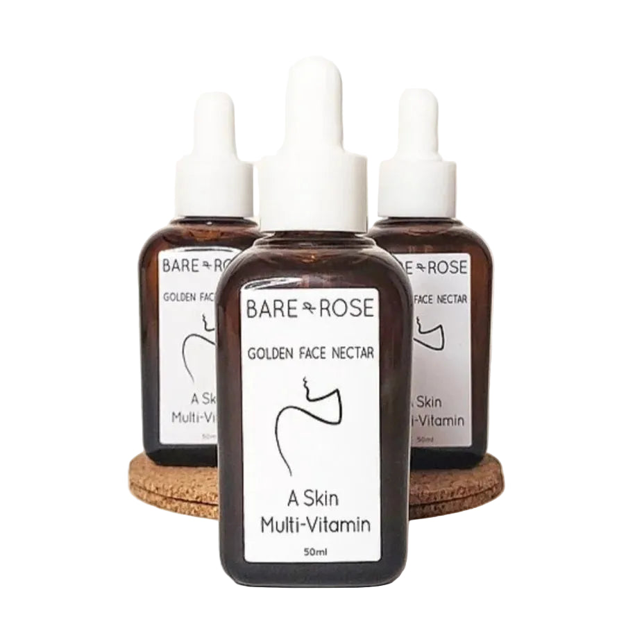 3 bottles of bare & rose organic face oil on a white background.